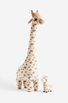 a giraffe and its baby are standing next to each other on a white background