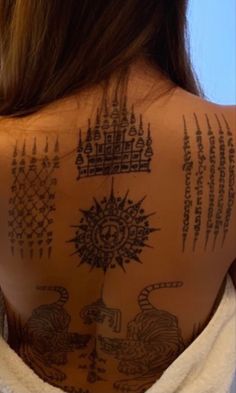 a woman with tattoos on her back