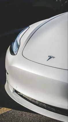 the front end of a white sports car