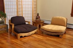 two chairs and a table in a room with wood flooring, one chair has a cushion on it