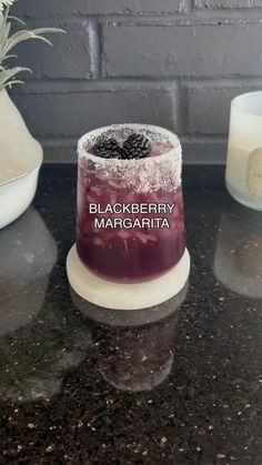 a black berry margarita sitting on top of a counter