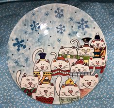 a plate decorated with cats and snowflakes