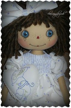 the doll is wearing a white dress with blue eyes