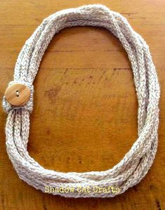 a white rope with a wooden button on it