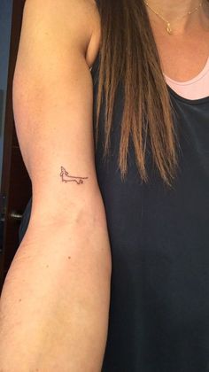 a woman with a small tattoo on her arm