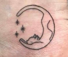 a cat sleeping on the moon with stars in it's back side tattoo design