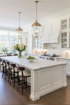 a large kitchen with an island in the middle and lots of counter space on one side