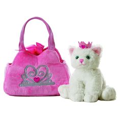 a white cat sitting next to a pink handbag with a tiara on it