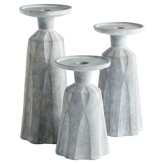 three white vases sitting next to each other