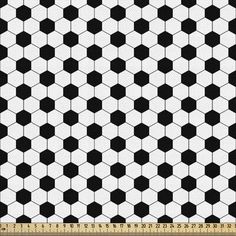 a black and white checkered pattern on fabric with a ruler in the foreground