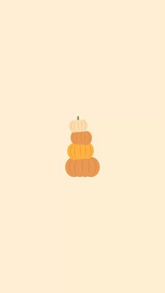 a stack of pumpkins sitting on top of each other in front of a beige background