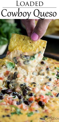 a hand dipping a tortilla chip into a black bean and cheese quesadilla dip