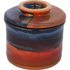 a brown and blue jar with a wooden lid