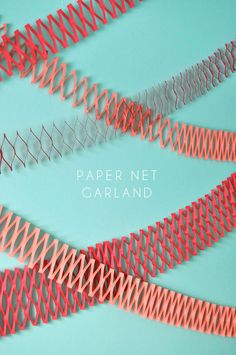 some red and orange wire on a blue background with the words paper net garland written below it