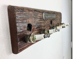 a coat rack made out of wood with three different knobs and two white handles