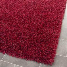 a red rug on the floor in a room