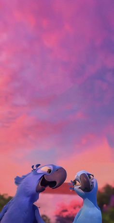 two blue birds standing next to each other in front of a pink and purple sky