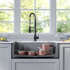 a kitchen sink with pots and pans in it