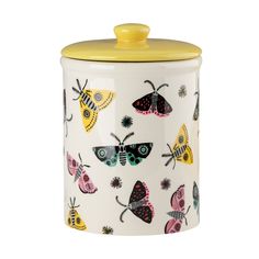 a white canister with colorful butterflies painted on the side and yellow lid, in front of a white background