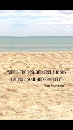 a person sitting on top of a sandy beach next to the ocean with a quote above it