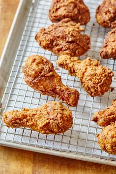 some fried food is on a cooling rack and ready to be cooked in the oven