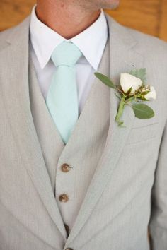 a man in a suit with a boutonniere on his lapel