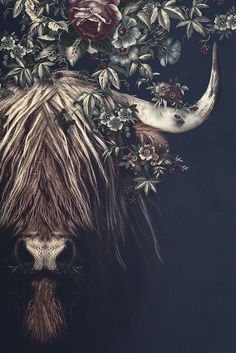 an animal with long horns and flowers on it's head is standing in front of a dark background