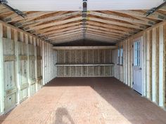 an empty room with wooden walls and flooring in the process of being built by someone