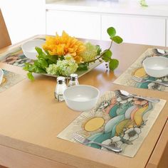 a wooden table topped with plates and bowls