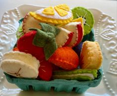 a basket filled with lots of different types of stuffed animals on top of a white plate