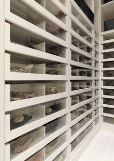 an organized closet with lots of shelves and bins