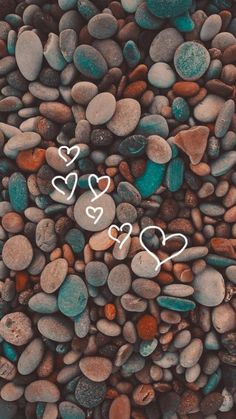 some rocks and pebbles with hearts drawn on them