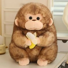 a stuffed monkey with a banana in its hand