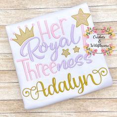 a white shirt that says her royal threenesss and gold stars on the front