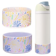 thermos and cups are sitting next to each other on a white surface with flowers painted on them