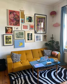 a living room filled with furniture and lots of pictures on the wall above it's coffee table