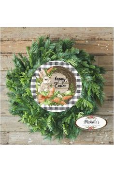 a wreath with an image of a bunny and carrots on it, sitting next to a sign that says happy easter