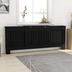 a living room scene with focus on the sideboard and rug in the foreground