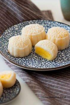 four moon cakes on a blue and white plate