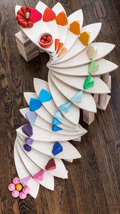 a bunch of paper flowers sitting on top of a wooden floor