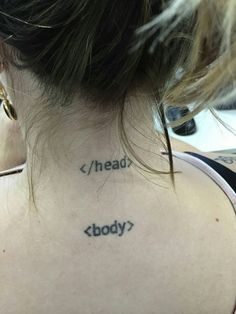 the back of a woman's neck with words tattooed on her upper and lower body