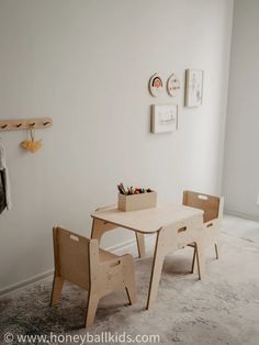 a wooden table and two chairs in a room