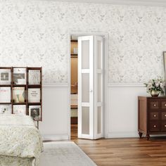 a bedroom with white walls and wooden floors