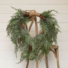 a wooden chair with a wreath on it