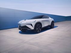 an all - electric vehicle is shown in front of a blue wall and concrete floor