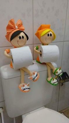 two cartoon figures sitting on top of a toilet