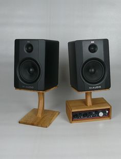 two wooden speakers sitting on top of each other