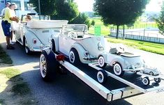 an antique car being towed by a trailer