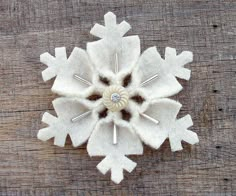 a white snowflake sitting on top of a wooden table