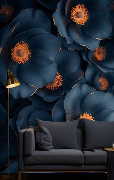 a living room scene with focus on the couch and wallpaper that has large blue flowers